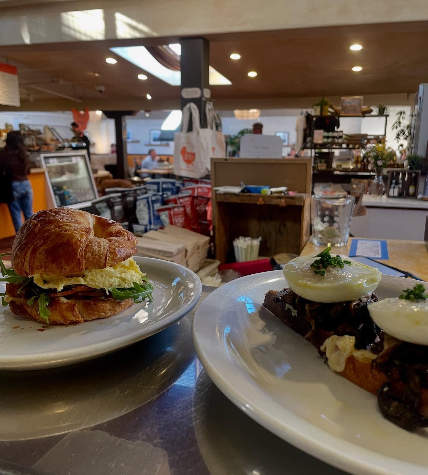 Croissant breakfast sandwich and mushroom benedict