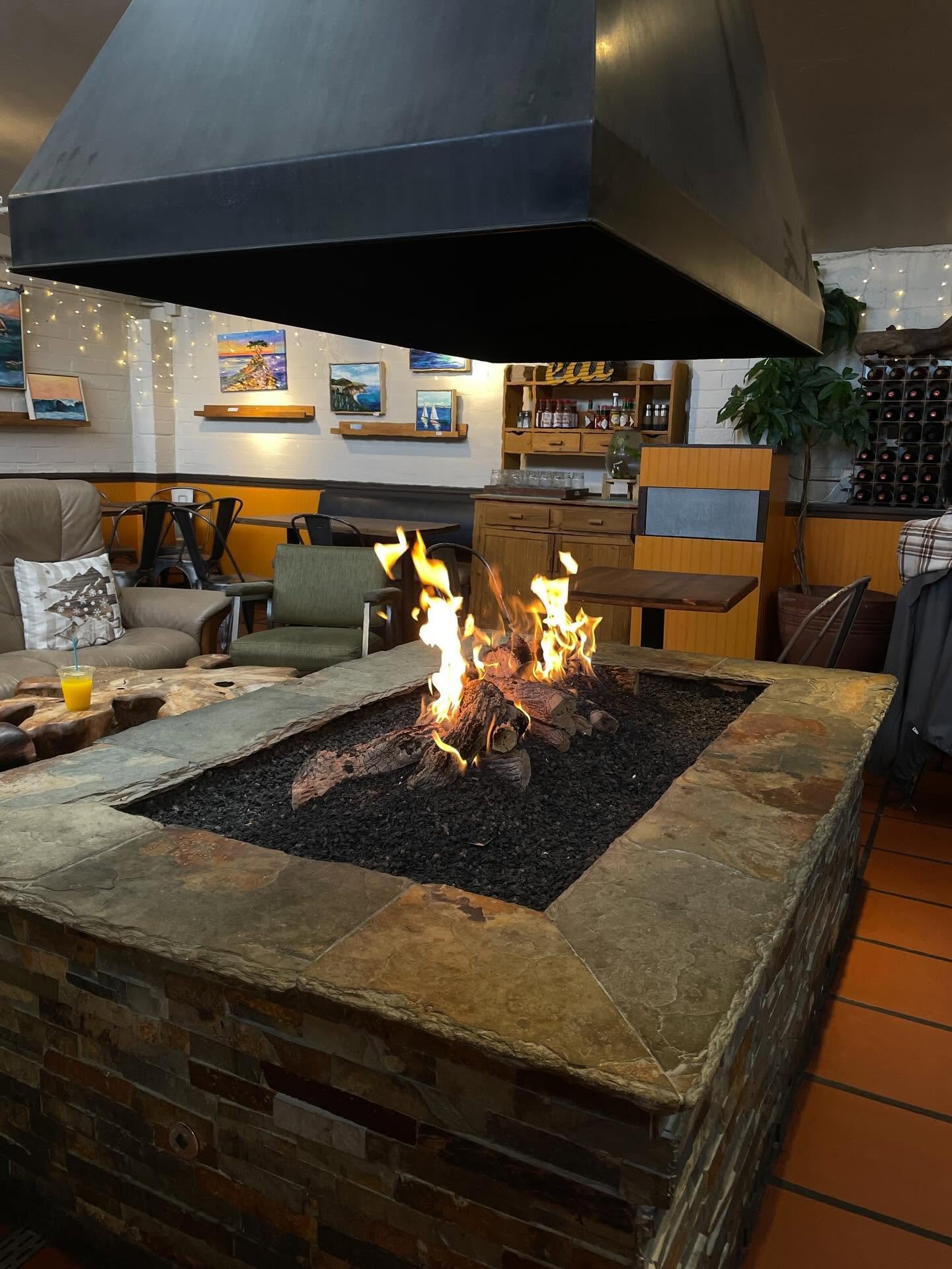 Cozy interior with a stone fireplace and local artwork