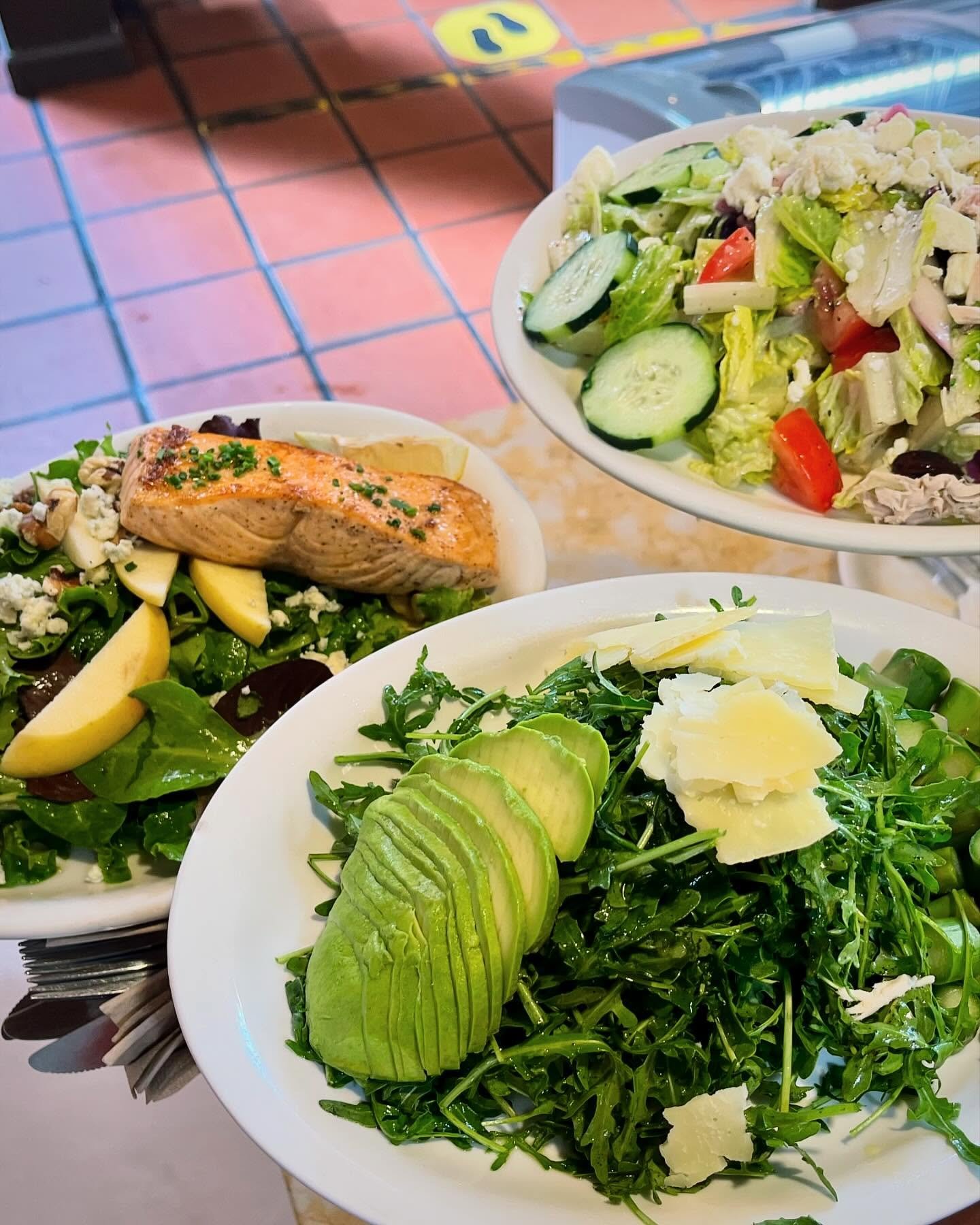 Seared salmon over greens and arugula salads